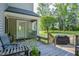 Enjoy a covered back porch with seating, offering a peaceful view of the fenced backyard at 726 Thomas Rd, Rocky Mount, NC 27801