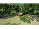 Backyard view shows green trees and shrubbery and a small stream at 726 Thomas Rd, Rocky Mount, NC 27801