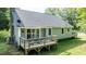 Home's lovely backyard deck, accessible through glass doors, offers a perfect spot for outdoor enjoyment at 726 Thomas Rd, Rocky Mount, NC 27801
