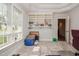 Versatile bedroom with bright light, carpeted floor, and built-in shelving for storage at 726 Thomas Rd, Rocky Mount, NC 27801