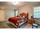 Cozy bedroom with wood furniture, windows with blinds, and carpet flooring at 726 Thomas Rd, Rocky Mount, NC 27801