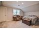 Comfortable bedroom with a sofa, window, bed, and carpet floors at 726 Thomas Rd, Rocky Mount, NC 27801