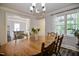 Well-lit dining room with a round table and view into the kitchen at 726 Thomas Rd, Rocky Mount, NC 27801