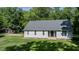 View of this home's exterior shows its large yard and a separate storage shed at 726 Thomas Rd, Rocky Mount, NC 27801