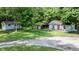 Scenic home exterior surrounded by lush greenery offers a peaceful, private setting at 726 Thomas Rd, Rocky Mount, NC 27801