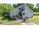 View of home exterior with deck, green backyard and chain link fence at 726 Thomas Rd, Rocky Mount, NC 27801