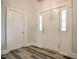 Bright foyer featuring a paneled door and wood-look flooring at 726 Thomas Rd, Rocky Mount, NC 27801