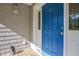 Close-up of a blue front door with white trim and decorative sidelights, enhancing curb appeal at 726 Thomas Rd, Rocky Mount, NC 27801