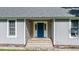 Charming home featuring a bright blue front door with decorative glass accents and covered porch entry at 726 Thomas Rd, Rocky Mount, NC 27801