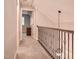 Upstairs hallway with neutral walls, carpet and black metal railing at 726 Thomas Rd, Rocky Mount, NC 27801