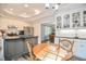 Well-lit kitchen nook featuring a wooden table and chairs next to the elegant granite countertops at 726 Thomas Rd, Rocky Mount, NC 27801
