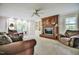 Bright living room featuring a fireplace, large windows, plush seating, and built-in cabinets at 726 Thomas Rd, Rocky Mount, NC 27801