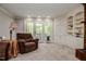 Cozy living room featuring a recliner, built-in cabinets, and french doors at 726 Thomas Rd, Rocky Mount, NC 27801