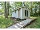 Charming outbuilding provides additional space, complimented by a wooden walkway at 726 Thomas Rd, Rocky Mount, NC 27801
