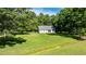Aerial view of a home with a large front yard surrounded by mature trees at 726 Thomas Rd, Rocky Mount, NC 27801