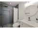 Modern bathroom features a walk-in shower with rain shower head and pebble floor at 7611 Satinwing Ln, Raleigh, NC 27617