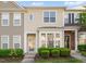 Inviting townhome featuring classic siding, manicured landscaping, and a welcoming entrance at 7611 Satinwing Ln, Raleigh, NC 27617