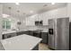 Stylish kitchen features stainless appliances, ample counter space, and pendant lighting at 7611 Satinwing Ln, Raleigh, NC 27617