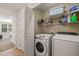 Convenient laundry room equipped with a washer, dryer, and wire shelving for efficient storage at 7611 Satinwing Ln, Raleigh, NC 27617