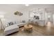 Open-concept living area with modern decor, hardwood floors, and breakfast bar at 7611 Satinwing Ln, Raleigh, NC 27617