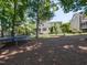 Large backyard with a trampoline and mature trees, providing a shaded and recreational outdoor space at 800 Skymont Dr, Holly Springs, NC 27540