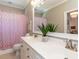 Bright bathroom featuring a double sink vanity, modern fixtures, and a charming pink polka dot shower curtain at 800 Skymont Dr, Holly Springs, NC 27540