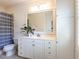 Bright bathroom with ample storage space, a large mirror, and a combination shower and bathtub at 800 Skymont Dr, Holly Springs, NC 27540