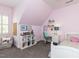 Cozy bedroom with sloped ceiling, a built-in bookcase, and playful decor, perfect for a or guest at 800 Skymont Dr, Holly Springs, NC 27540