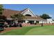 Exterior view of a clubhouse with a pitched roof, complemented by golf carts and manicured green lawns at 800 Skymont Dr, Holly Springs, NC 27540