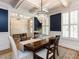 Elegant dining room with a crystal chandelier, wainscoting, and shuttered windows for natural light at 800 Skymont Dr, Holly Springs, NC 27540