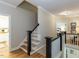 Traditional home hallway with wooden floors, white molding, and staircase leading to the second floor at 800 Skymont Dr, Holly Springs, NC 27540