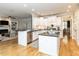 Spacious kitchen with white cabinets, dark countertops, stainless steel appliances, and hardwood floors at 800 Skymont Dr, Holly Springs, NC 27540