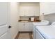 Well-equipped laundry room features a sink, ample storage, and modern washer and dryer at 800 Skymont Dr, Holly Springs, NC 27540
