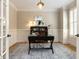 Cozy office with a stylish desk, hardwood floors, wainscoting, and ample natural light at 800 Skymont Dr, Holly Springs, NC 27540