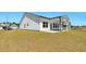 Exterior view of the home with a well-manicured lawn, patio, and modern siding at 823 Biltmore Dr, Sanford, NC 27332