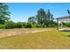 Spacious backyard featuring lush greenery and a covered patio at 823 Biltmore Dr, Sanford, NC 27332