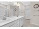 Modern bathroom featuring double sinks, granite countertops, and a separate shower for added convenience at 823 Biltmore Dr, Sanford, NC 27332