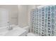 Bright bathroom with a decorative shower curtain, white vanity, and modern fixtures at 823 Biltmore Dr, Sanford, NC 27332