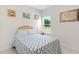 Cozy bedroom featuring neutral colors, a patterned bedspread, and a bright window view at 823 Biltmore Dr, Sanford, NC 27332
