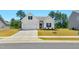 Charming one-story home showcasing a manicured lawn, flower beds, and a two-car garage at 823 Biltmore Dr, Sanford, NC 27332