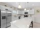 Bright kitchen features white cabinetry, stainless steel appliances, granite counters, and pendant lighting at 823 Biltmore Dr, Sanford, NC 27332