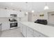 Open-concept kitchen with white cabinets, stainless appliances, a center island, and an adjacent living area at 823 Biltmore Dr, Sanford, NC 27332