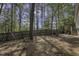 This backyard features a wooden fence, a swing set and a seating area with a grill at 900 Finchurch Cir, Wake Forest, NC 27587