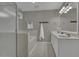 Bright bathroom featuring double sinks, white cabinetry, large mirror, and combination shower and tub at 900 Finchurch Cir, Wake Forest, NC 27587