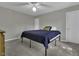 Bright bedroom with neutral walls, ceiling fan, and gray carpet flooring at 900 Finchurch Cir, Wake Forest, NC 27587