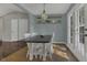Bright dining area featuring a farmhouse-style table, decorative lighting, and access to the outdoors at 900 Finchurch Cir, Wake Forest, NC 27587