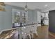 Stylish dining area with modern lighting, a large table, and access to outdoor space at 900 Finchurch Cir, Wake Forest, NC 27587