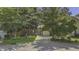 Charming brick home with mature trees and a well-manicured lawn enhancing curb appeal at 900 Finchurch Cir, Wake Forest, NC 27587