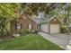 Well-maintained brick home offering a two-car garage, lush landscaping, and a welcoming curb appeal at 900 Finchurch Cir, Wake Forest, NC 27587