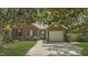 Charming brick home with mature trees, a well-maintained lawn, and a convenient two-car garage at 900 Finchurch Cir, Wake Forest, NC 27587